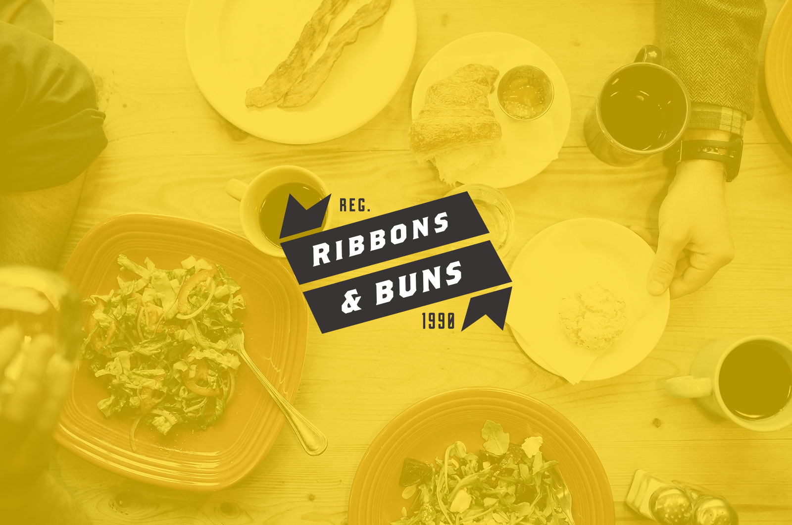 Dining table with dishes and branding logo.